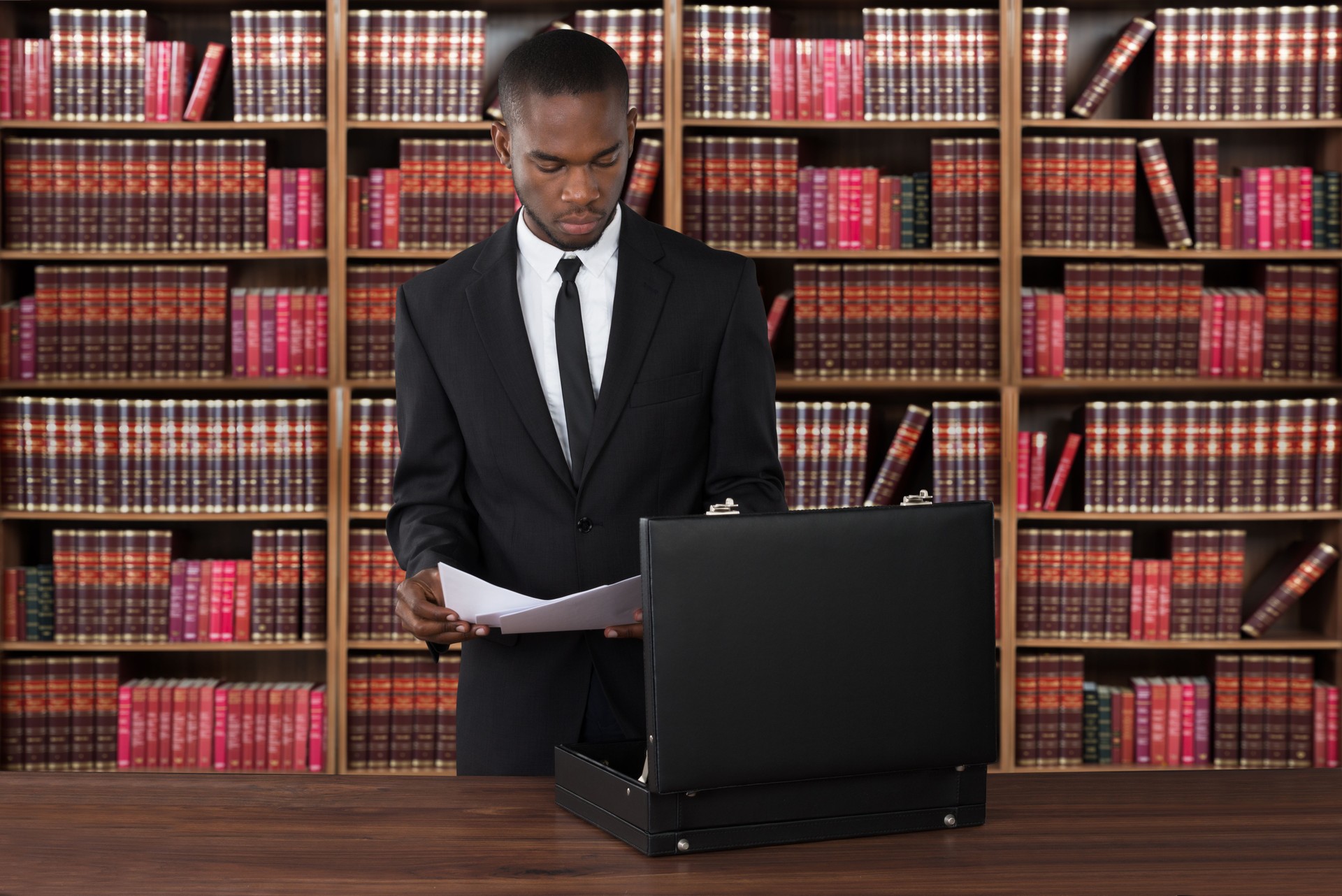 Lawyer With Papers And Briefcase At Desk